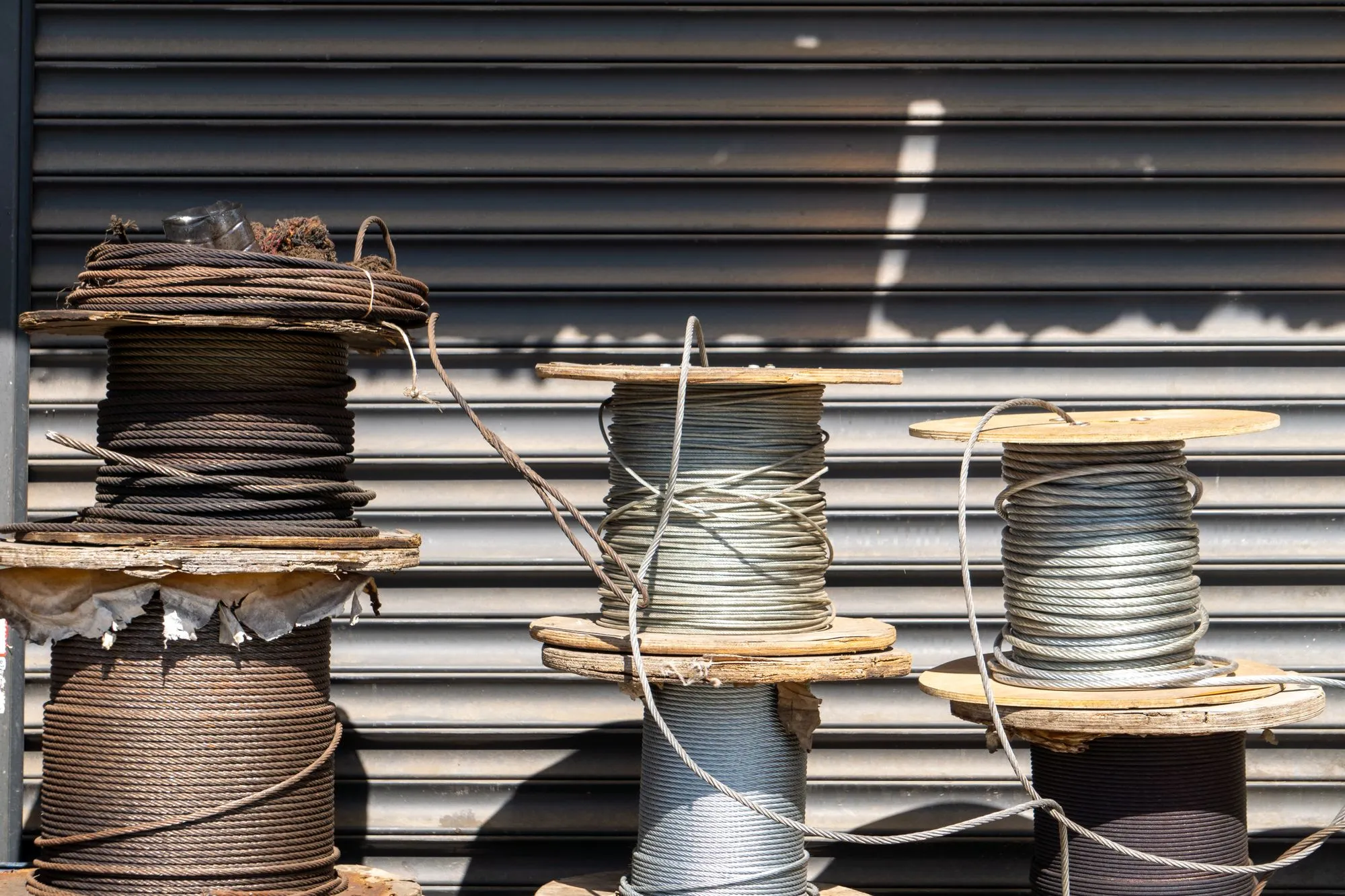 Several spools of industrial cable lined up outdoors