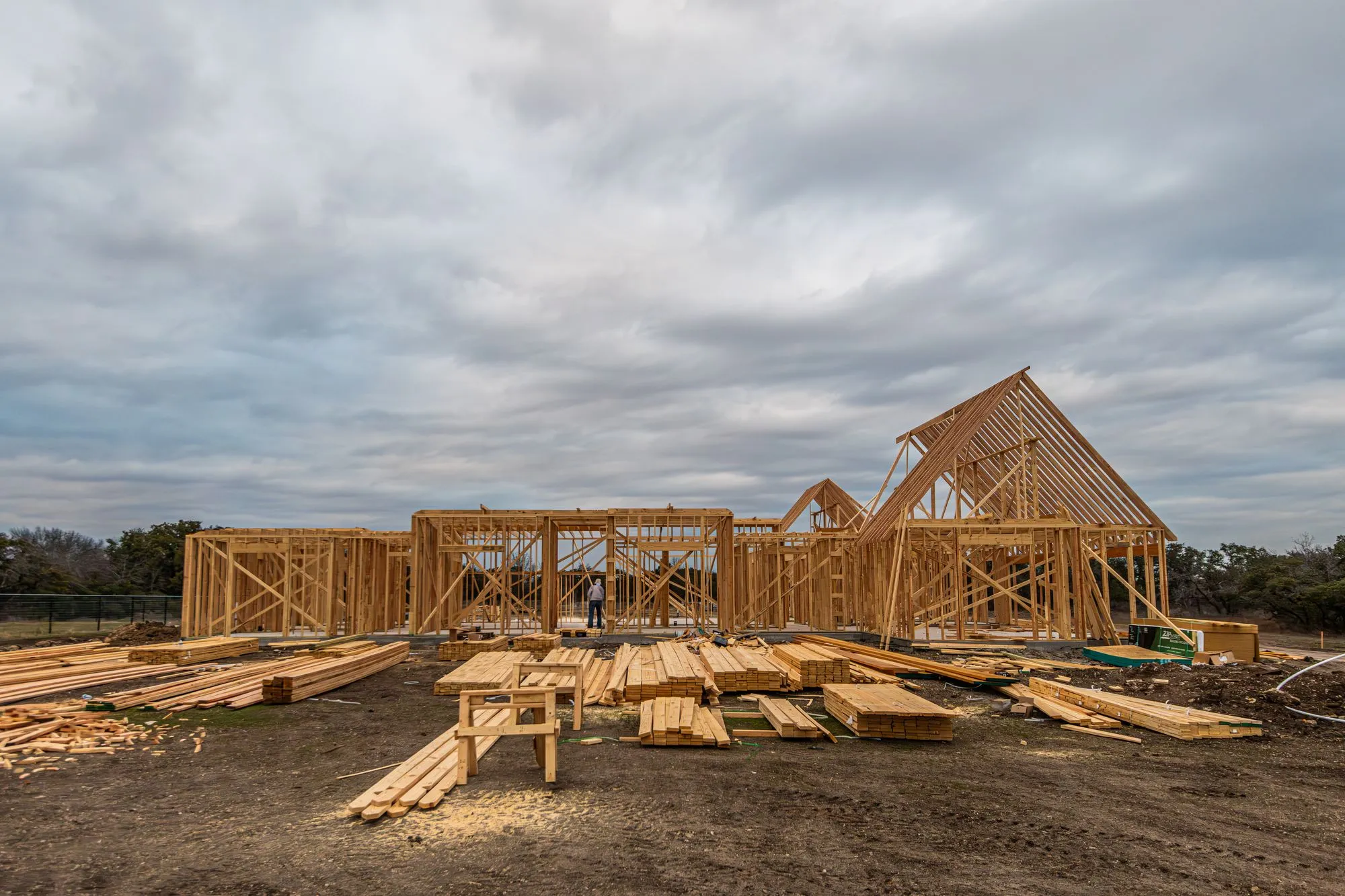 Wood framing of new houses under construction on a cleared lot