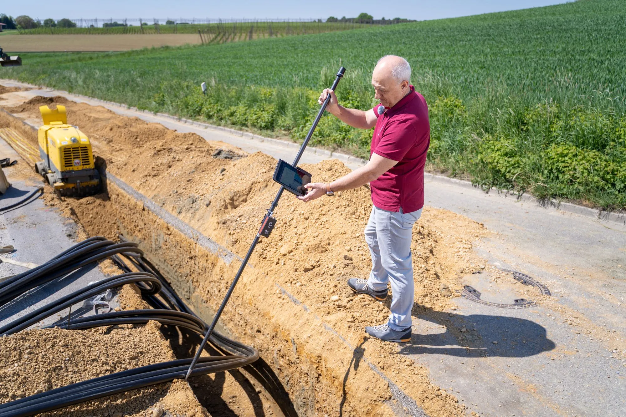 Long open utility trench with conduit laid along the bottom